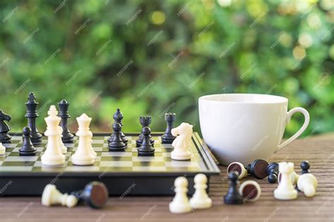 Premium Photo | Coffee cup on wood table with Chess board