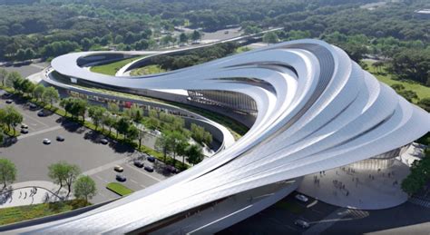 An Aerial View Of A Curved Building With Cars Parked In The Parking Lot