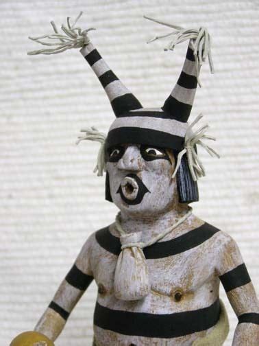 A Ceramic Figurine Is Dressed In Black And White Stripes