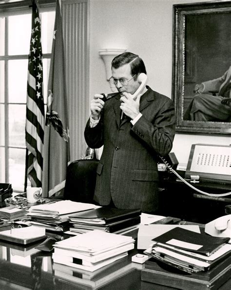 Defense Secretary Donald H Rumsfeld Speaks On The Phone Smoking His