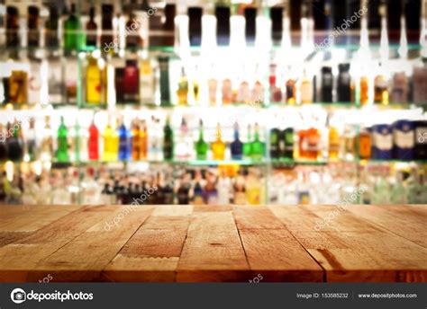 Wood Bar Top On Blur Colorful Alcohol Drink Bottle Background Stock