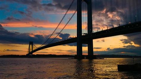 Premium Photo Suspension Bridge Over River During Sunset