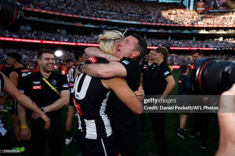 Darcy Moore Of The Magpies And Magpies Head Coach Craig Mcrae Hug