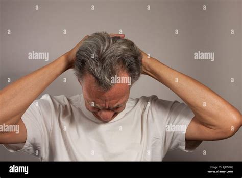 Mature Man Plus Doing Back Of The Neck Stretches For Back And Neck