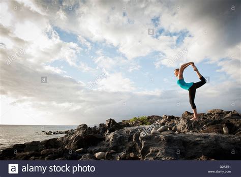 Woman Practicing Yoga On Rock Formation Stock Photo Alamy