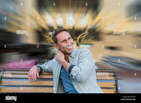 Portrait Of Smiling Mature Man Sitting On Wooden Bench Stock Photo Alamy