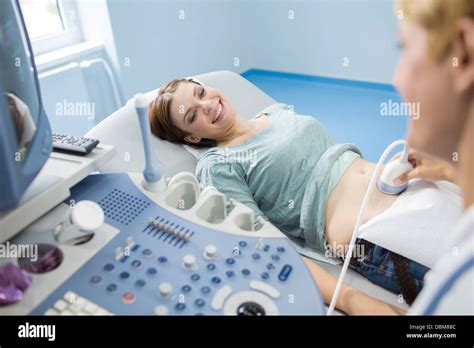 Pregnant woman having an ultrasound Stock Photo - Alamy