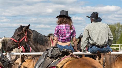 Cowboy Couple Sit Back and Behold Stock Image - Image of back, cowboy ...