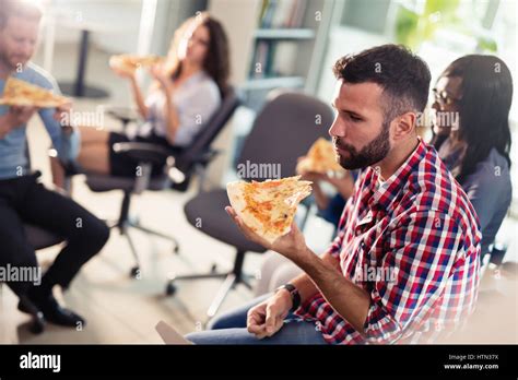 Colleagues Corporate Lunch Break At Work In Company Offices Stock Photo