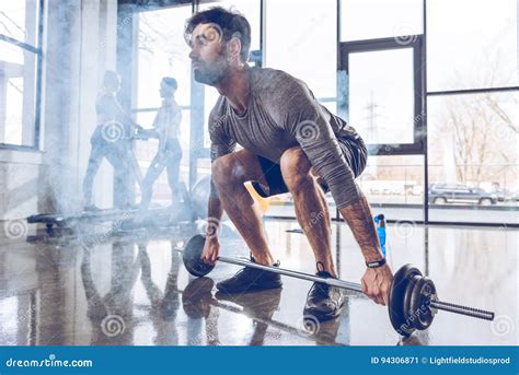 Muscular Sportsman Lifting Barbell At Gym Workout Stock Image Image