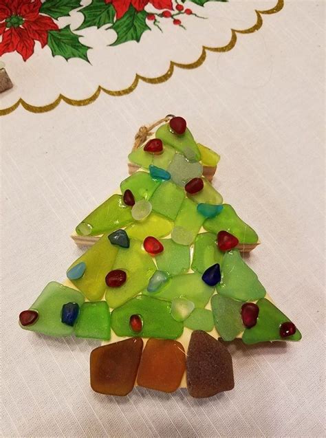 A Small Christmas Tree Made Out Of Stained Glass And Sea Glass On A