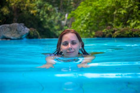 Relaxed Woman in Open Swimming Pool. Swimming Girl Looking in Camera ...