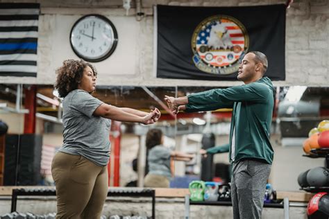 Experienced trainer showing exercises for black woman · Free Stock Photo