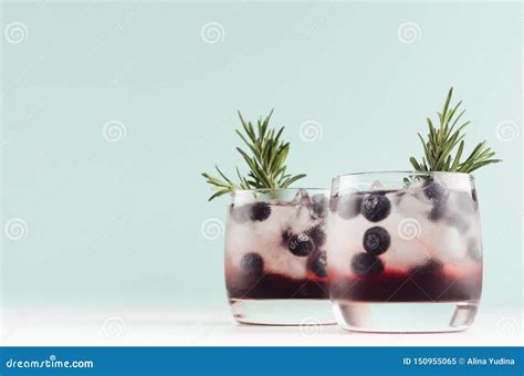 Sweet Alcoholic Cocktails With Ice Cubes Blueberry Rosemary In Two