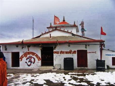 a man standing in front of a white building with red and orange flags on it