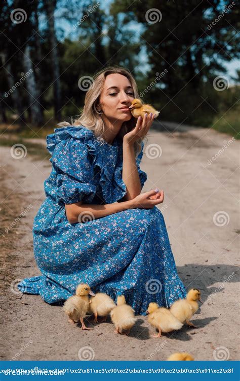 Belle Jeune Blonde Dans Une Robe Bleue Dans Les Bois Avec Canards Photo