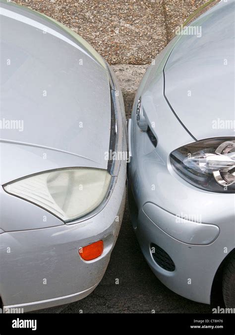 Two cars badly parked bumper to bumper - France Stock Photo - Alamy