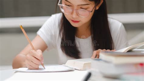 Asian Student Women Reading Books In Library At University Young