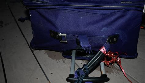 Grisly photos show luggage containing woman's remains