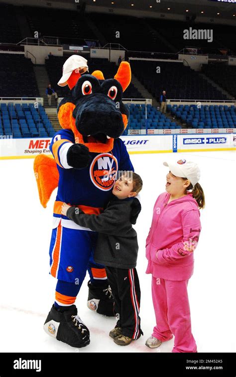 Two children greet Sparky, the dragon mascot for the NHL New York ...