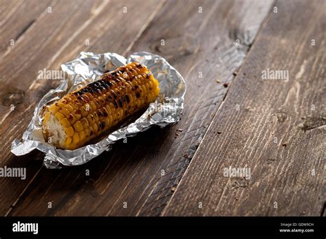 Grilled corn in aluminum foil Stock Photo - Alamy