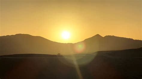 Premium Stock Video Timelapse Sun Rising Over Mountain Peaks In