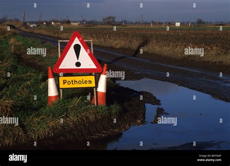 Sign Warning Drivers Of Potholes On Country Road Yorkshire Uk Stock