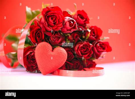 Flower roses bouquet on red background / Red heart with ribbon and rose ...