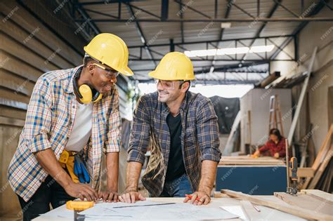 Premium Photo Two Carpenter Man Wear Helmet Meeting Planning Job