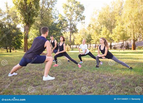 Group Of Young Sporty People Doing Exercise Outdoors Stock Image