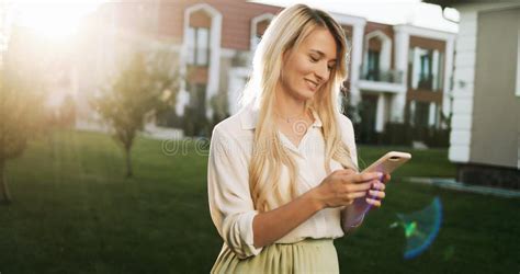 Close Up Of Smiling Attractive Girl With Long Hair Talking On Mo Stock