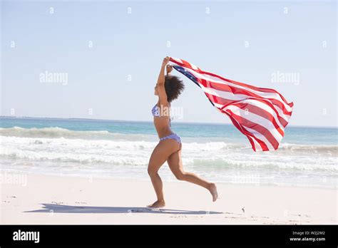 Woman In Bikini With American Flag Running On The Beach Stock Photo Alamy