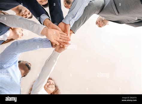 Group Of Business People Putting Hands Together In Office Bottom View