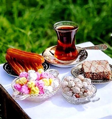 A Table Topped With Desserts And Drinks On Top Of A White Table Cloth