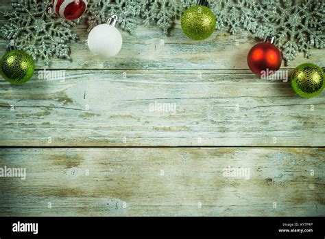 Green And Red Christmas Ornaments And Snow Flakes Bordering A Vintage