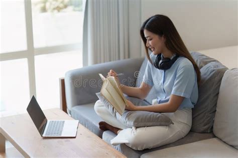 Attractive Asian Woman Resting Comfortable Living Room And Reading Book