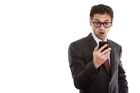 Premium Photo Young Businessman Wearing Eyeglasses While Using Smartphone