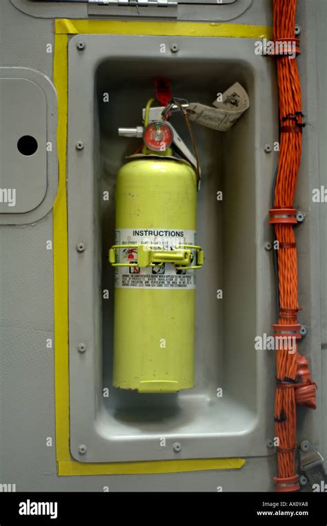 Closeup of fire extinguisher in interior of military cargo aircraft ...