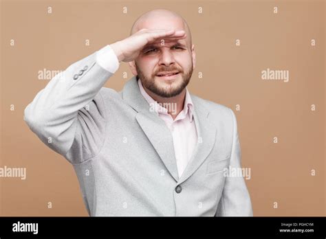 Portrait Of Confused Handsome Middle Aged Bald Bearded Businessman In