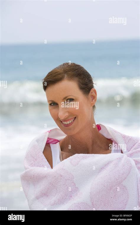 Woman Wrapped In Beach Towel Stock Photo Alamy