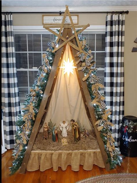 a nativity scene is displayed in front of a window