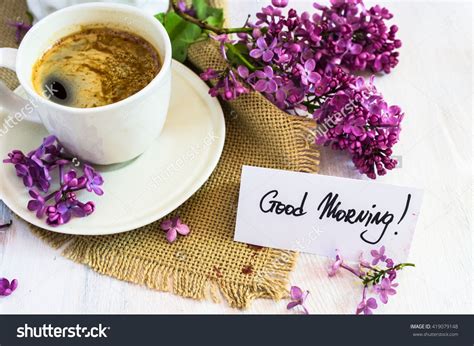 Lilac Flowers And Cup Of Coffee With Good Morning Note On Rustic Wooden