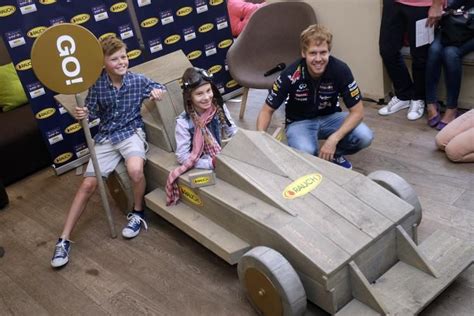 Sebastian Vettel With Two Young Fans During An Autograph Session At