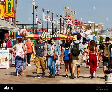 Large Crowd Of People Walking On The Boardwalk At Coney Island Very