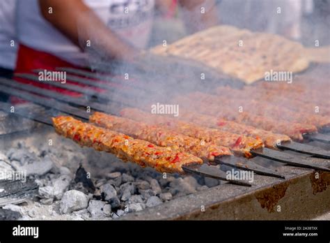 Traditional Turkish Adana Kebab Or Kebap On The Grill With Skewers In