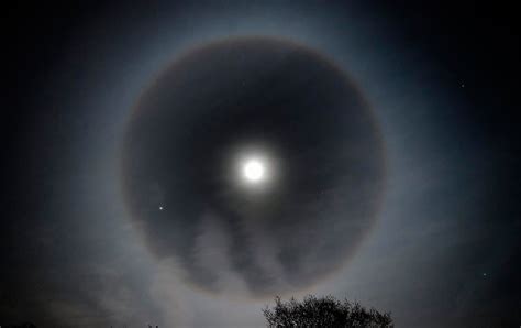 A moon halo spotted over London. The phenomenon is caused by ice crystals in the atmosphere ...