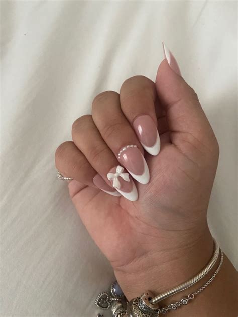 Cute White French Tip Almond Nails With Bow And Pearl Detail