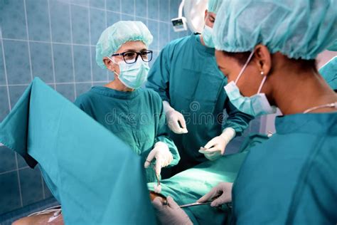 Surgery Team Operating in a Surgical Room Stock Photo - Image of clinic ...