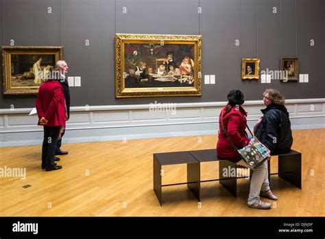 Visitors looking at collection of old paintings in the Museum of Fine ...