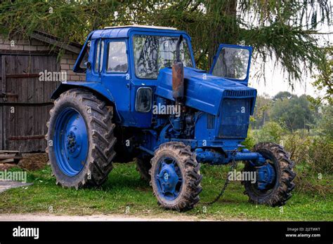 Old vintage blue tractor in the countryside Stock Photo - Alamy